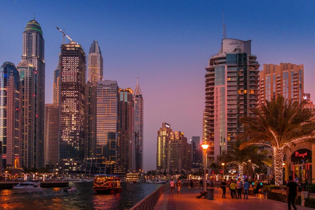 A stunning view of the Dubai Marina skyline illuminated at sunset, showcasing urban city life.