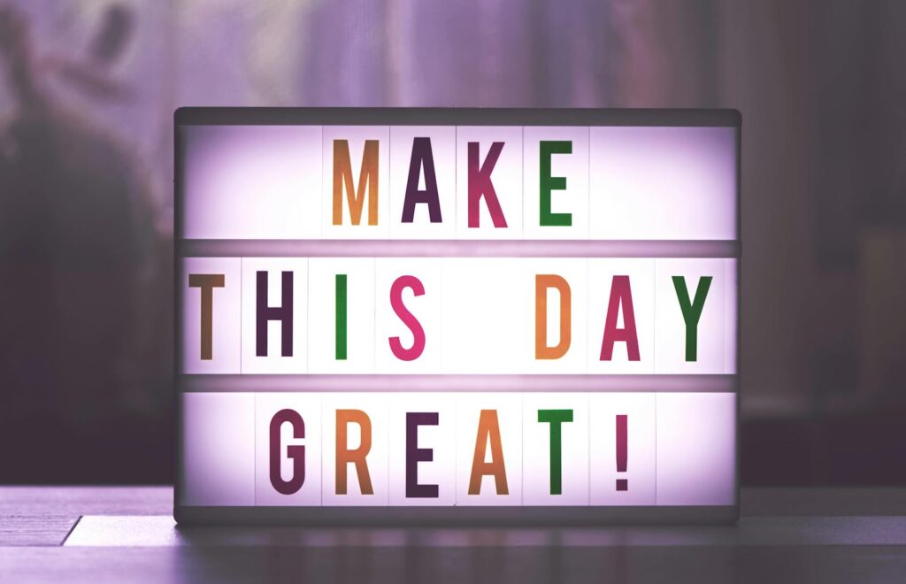 Inspirational sign displaying 'Make This Day Great' in colorful letters.