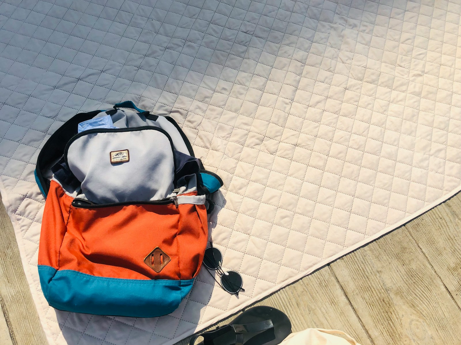 black and orange backpack on white floor