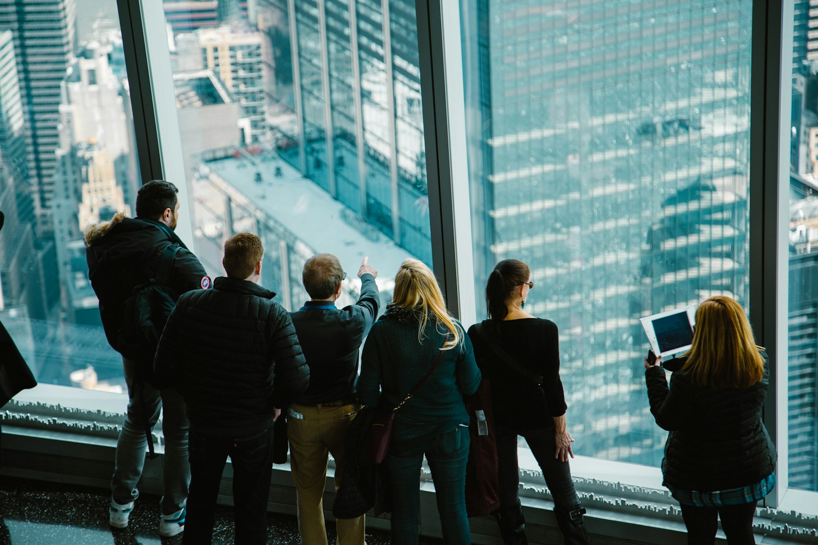 group of people in building looking outside