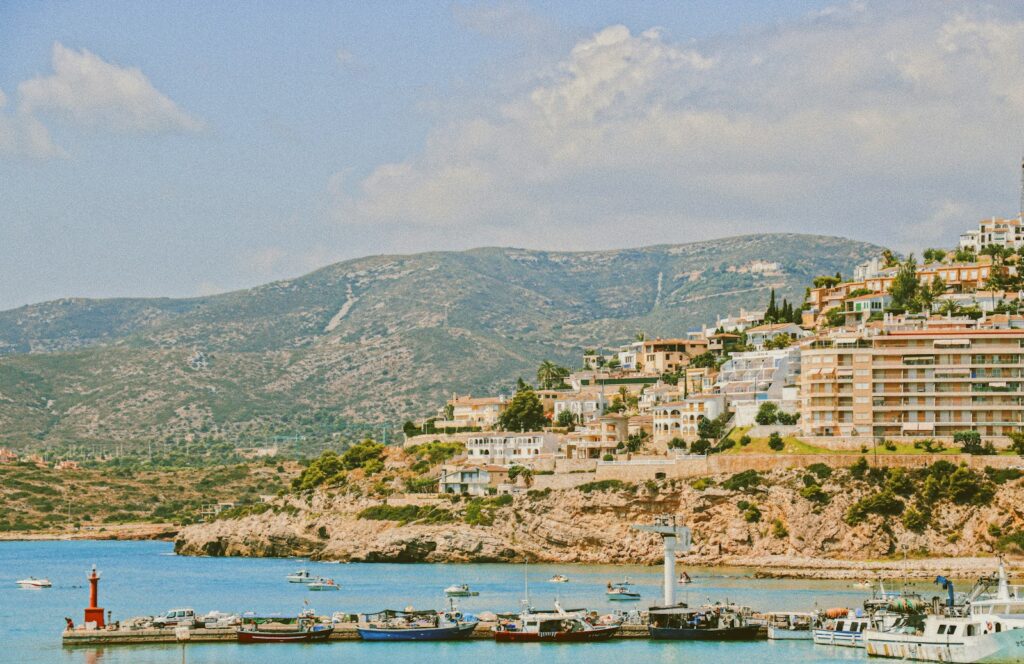 white and brown concrete buildings near body of water during daytime